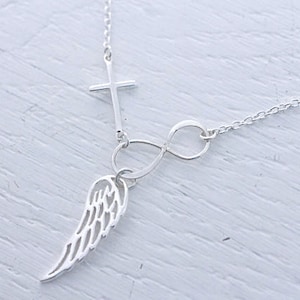 May include: Silver necklace with a cross, infinity symbol, and a single wing charm.