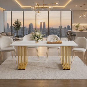 May include: A rectangular dining table with a white top and two gold-colored vertical slat bases. The table is surrounded by four cream-colored upholstered chairs with gold-colored metal legs, set upon a light gray area rug in a room.