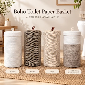 May include: Four cylindrical woven rope baskets with lids and small brown leather tabs. The baskets are available in solid white, solid khaki, solid beige, and a colour-blocked white and brown design. Each basket features a vertical rope texture.