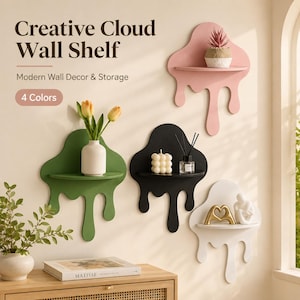 May include: Four wall shelves shaped like melting clouds in pink, green, black, and white. Each shelf features a flat horizontal surface for display. The pink shelf holds a small potted plant, the green shelf holds a vase with tulips, the black shelf holds a candle and reed diffuser, and the white shelf holds a gold heart sculpture and a small figurine.