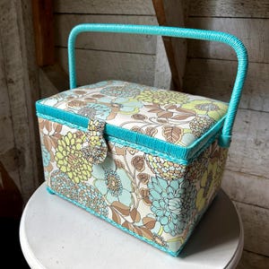 70s sewing basket - padded floral design satin lining sewing basket wrapped handle pin cushion plastic tray turquoise handle and inside