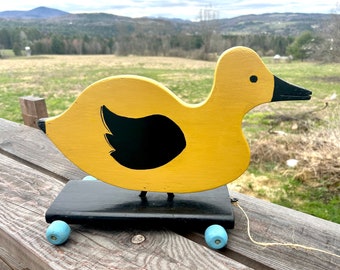 Vintage yellow duck pull toy handmade blue wheels folk art hand painted duck sculpture