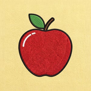 May include: An embroidered patch of a red apple with a green leaf and a brown stem, featuring a white curved highlight on the upper left side. The apple is outlined in black thread and is set against a pale yellow, textured fabric background.