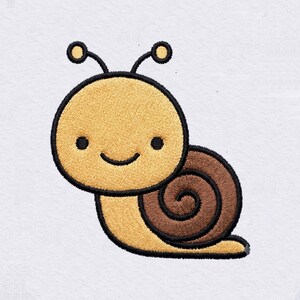May include: An embroidered patch featuring a cartoon snail with a yellow head and body, a brown spiral shell, and black outlines. The snail has two antennae with yellow tips, two small black eyes, and a simple curved black line for a mouth.