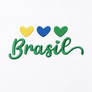 May include: An embroidery design on a white background featuring the word Brasil in green cursive script. Above the text are three small embroidered hearts in yellow, blue, and green, arranged horizontally in a row above the lettering.