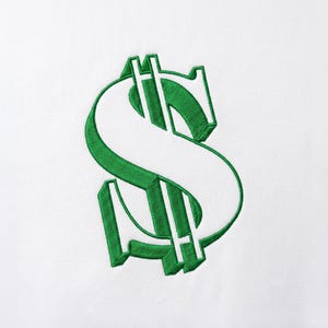 May include: A white fabric surface featuring a large, centered dollar sign symbol. The dollar sign is rendered in a bold, three-dimensional style with thick, vibrant green embroidery thread outlining the shape and creating a distinct shadow effect.
