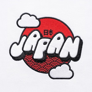 May include: An embroidered patch on a white fabric background featuring a large red circle with a black wave pattern at the bottom. The word JAPAN is stitched in large white letters with black outlines, and two white clouds are positioned at the corners.