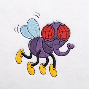 May include: An embroidered design on a white fabric surface featuring a cartoon fly with a purple body, large red compound eyes, light blue wings, and four yellow feet. The fly has a curved trunk-like nose and black legs in a flying pose.