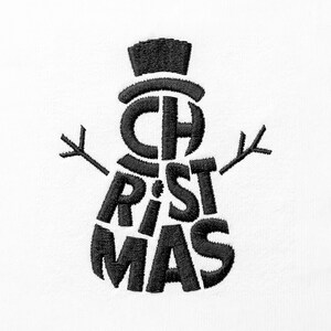 May include: A black embroidered design on a white fabric surface featuring the word CHRISTMAS arranged to form the shape of a snowman. The top hat, head, and body are composed of bold black letters with two stick-like arms extending outwards.