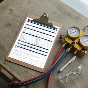 May include: A brown clipboard holding an HVAC service form with blue text, accompanied by a yellow manifold gauge set with red and blue hoses, a white pen, and clear safety glasses. The form includes sections for customer details.