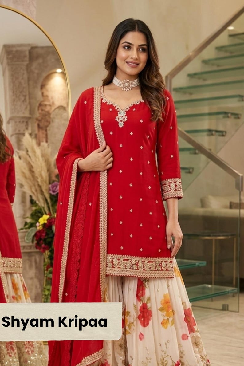 May include: A red kurta with three-quarter sleeves, a scalloped neckline, and gold embroidery, paired with a white floral print skirt and a matching red dupatta with a gold border. The text Shyam Kripaa is visible at the bottom of the image.