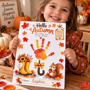May include: A white craft sheet featuring the text Hello Autumn, Good things grow in cozy seasons, and Always Be Kind Always Be You. The design includes a handprint, yellow rain boots, a brown umbrella, a squirrel, and red maple leaves.