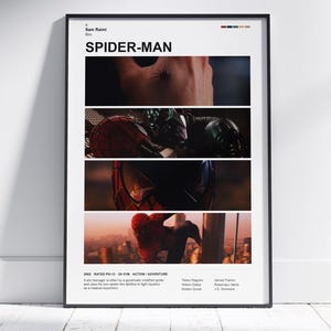 May include: A framed movie poster for Spider-Man directed by Sam Raimi. The white poster features four horizontal film stills showing a close-up of skin, a masked figure, a red and blue mask, and a character climbing a building at sunset.