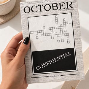 May include: A rectangular card featuring a vintage newspaper background with the word OCTOBER at the top, a central crossword puzzle grid, and a black rectangular box at the bottom containing the white text CONFIDENTIAL and Atelier Lonnee.