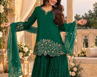 May include: A dark green three-piece outfit consisting of a long-sleeved tunic with gold floral embroidery at the neckline and hem, a pair of wide-leg pleated pants with small gold accents, and a matching sheer dupatta with scalloped edges.