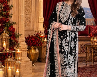 May include: A black velvet long-sleeved tunic and matching wide-leg trousers featuring intricate silver and pink floral embroidery, paired with a coordinating black and pink embroidered shawl draped over the shoulder.