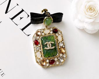Vintage Chanel Gold-Tone Black Enamel Lion Doll Pearl Brooch with Bag