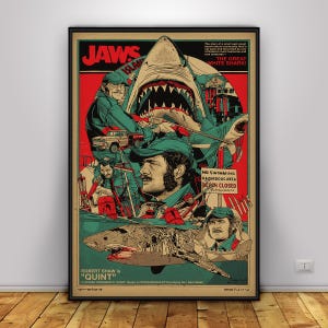 Puede incluir: Un póster vertical con el título JAWS en letras rojas, un gran tiburón e ilustraciones del personaje Quint. La obra incluye textos como THE GREAT WHITE SHARK, NO SWIMMING HAZARDOUS AREA BEACH CLOSED y ROBERT SHAW QUINT.