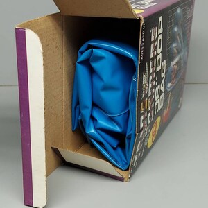 May include: A blue inflatable bag in a cardboard box with the text "The Future is 36: Bop Bag" on the side. The box is open and the bag is partially visible.