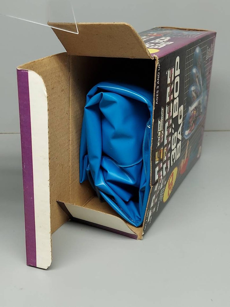 May include: A blue inflatable bag in a cardboard box with the text "The Future is 36: Bop Bag" on the side. The box is open and the bag is partially visible.