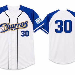 May include: A white and blue baseball jersey featuring the text Charros in gold script with a baseball graphic on the front, the number 30 in blue on the front and back, and a Chicago flag patch on the left sleeve. The shirt has a button-down front.