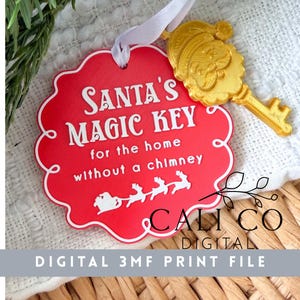 May include: A red scalloped ornament with white text reading Santa's Magic Key for the home without a chimney, featuring a white silhouette of Santa and reindeer. A gold-colored key with a Santa face design is attached by a white ribbon.