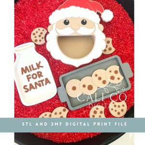 May include: A Santa Claus face cutout with a hollow mouth, a white milk bottle cutout with the text MILK FOR SANTA, and a grey rectangular tray containing several round cookie cutouts with brown spots, all resting on a bed of red rice.