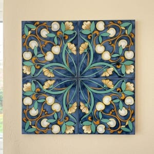 May include: A square wall art piece composed of four tiles featuring a symmetrical floral pattern. The design displays yellow flowers, teal green leaves, and white circular buds set against a deep blue background with swirling golden brown vines.