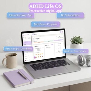 May include: A silver laptop displaying the ADHD Life OS Interactive Digital App dashboard, surrounded by a beige mug, a light purple notebook with a pen, a small green succulent in a white pot, and white headphones on a desk.
