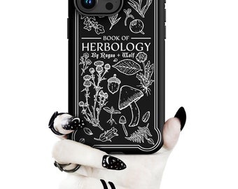 May include: Black phone case with a white outline of various plants and mushrooms. The text "Book of Herbology by Rogue + Wolf" is printed on the case.