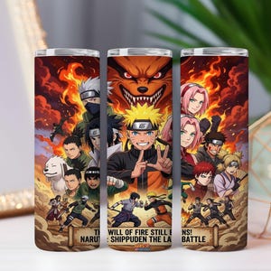 May include: A cylindrical tumbler featuring a vibrant, multi-character anime graphic from Naruto Shippuden. The design displays various characters, including Naruto, Sasuke, and Sakura, set against a backdrop of orange flames and a large fox face.