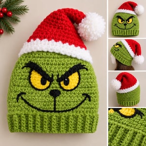 May include: A green crochet beanie hat featuring a character face with yellow eyes and a black stitched smile. The hat has a red top section with a white brim and a white pom-pom at the tip. The design includes a ribbed base and textured yarn.