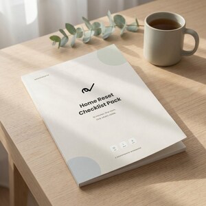 May include: A white workbook titled Home Reset Checklist Pack with a black logo and text, featuring the phrases 10 minutes. One room. Only what's visible. and A NODOPRONTO WORKBOOK, accompanied by a matte beige ceramic mug filled with dark liquid.