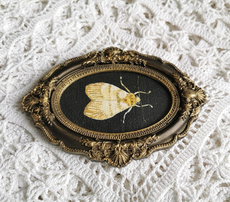 Original acrylic moth painting on plywood displayed in a vintage-inspired bronze decorative frame.