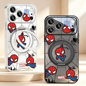 May include: Two smartphone cases featuring a Spider-Man pattern with red and blue character graphics, black spider web lines, and a small black spider icon. Each case includes a circular ring stand, a camera lens cutout, and the red Marvel logo.