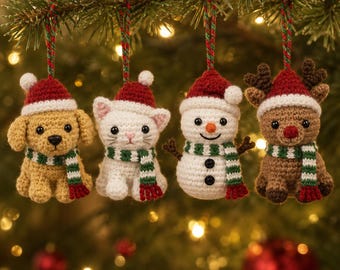 May include: Four crocheted Christmas ornaments hanging from a tree branch. The set includes a tan puppy, a white kitten, a white snowman, and a brown reindeer. Each figure wears a red Santa hat with a white trim and a green and white striped scarf.