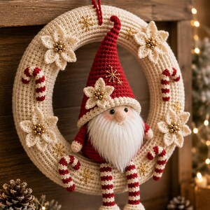 May include: A crocheted cream-colored wreath adorned with small red and white candy canes, cream-colored flowers with gold centers, and gold snowflake embroidery. A crocheted gnome with a red hat and striped legs sits on the wreath.