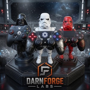 May include: Three character-themed controller stands featuring Darth Vader, a white Stormtrooper, and a red trooper, each holding a gaming controller. The base displays the text DARNFORGE LABS and the slogan CREATED. PRINTED. PERFECTED. in orange and white.