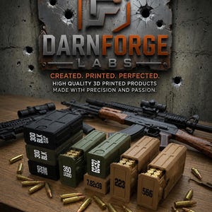 May include: A collection of stackable 3D printed ammunition storage boxes in black, olive green, and tan. The boxes are labeled with calibers including 300 BLK, 350 LEGEND, 7.62x39, 223, and 556, with loose cartridges scattered around them on a wooden surface.
