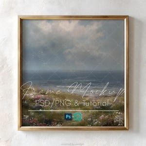 May include: A square gold-toned frame containing a landscape painting of a coastal scene with a dark, cloudy sky over a calm ocean. The foreground features a field of wild grasses and small pink and white flowers. Text overlays read Frame Mockup.