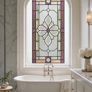 May include: A rectangular stained glass window insert featuring a central floral motif with clear textured glass, surrounded by deep purple and light tan border panels, all held together by dark metal cames within an arched window frame.