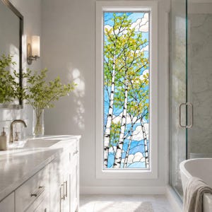 May include: A tall, rectangular window featuring a stained glass panel depicting birch trees with green and yellow leaves against a blue sky with white clouds. The window is set within a white frame, showcasing a detailed nature-inspired design.