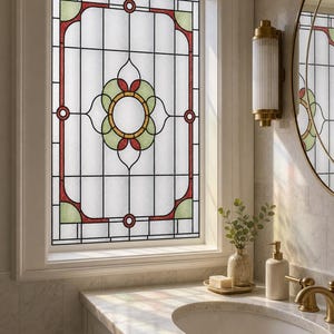 May include: A rectangular window film featuring a stained glass design with a central floral motif in green and red, surrounded by a geometric border. The pattern consists of clear, textured panels framed by thin black lines, creating a decorative look.