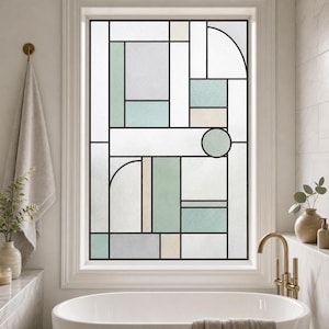 May include: A window film featuring a geometric pattern with black lines separating rectangular, square, and circular shapes. The design includes frosted white, soft sage green, and light beige panels, creating a grid-like stained glass effect.