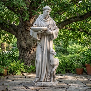 May include: A light grey stone statue of a robed figure with a beard, holding a shallow bowl with two small birds and a sunflower in one arm, while a small deer stands at the figure's feet, all resting on a textured stone base.
