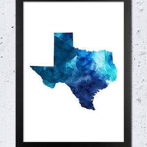 May include: A framed watercolor painting of the state of Texas in shades of blue. The painting is on a white background and is framed in a black frame.