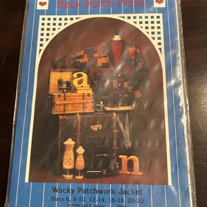 May include: A sewing pattern envelope titled Back Porch Press Wacky Patchwork Jacket, featuring a photograph of a patchwork jacket, two dress forms, a wooden letter a, a wooden letter n, a vintage sewing machine, and scissors, for sizes 6-22.