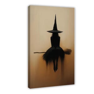 May include: A vertical canvas print featuring a dark silhouette of a figure wearing a tall pointed hat and a dress, sitting on a broomstick. The figure is rendered in deep black against a muted, light beige background with soft vertical textures.