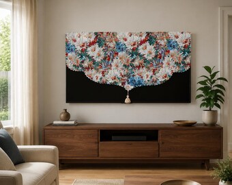 May include: A rectangular wall art piece featuring a dense, textured arrangement of white, blue, and red floral shapes against a solid black background, with a single beige tassel hanging from the center bottom edge of the floral design.