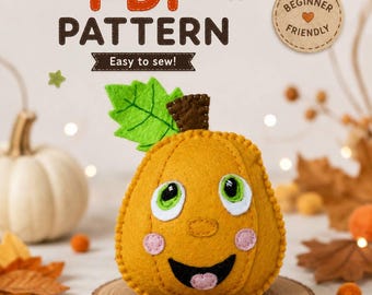 Puede incluir: Una manualidad de fieltro con forma de calabaza con cara sonriente, hoja verde y tallo marrón. El texto dice PDF PATTERN, Easy to sew! y BEGINNER FRIENDLY. La calabaza es naranja con ojos verdes y blancos, mejillas rosas y boca negra.